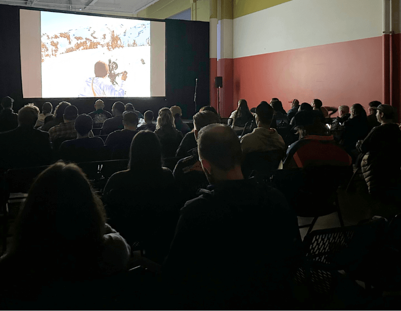 a crowd watching a film at Snowvana logo